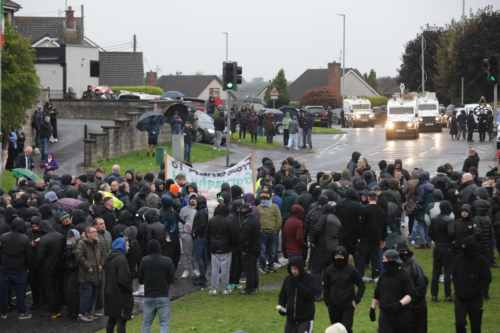 Protesters block the Garvaghy road ahead of a Portadown District Loyal Orange Lodge (LOL) No 1 march in the first parade for almost 30 years, after the parade was given clearance in a late-night hearing, in Portadown, Northern Ireland, Sunday, Sept. 27, 2026. (Peter Morrison/PA via AP)