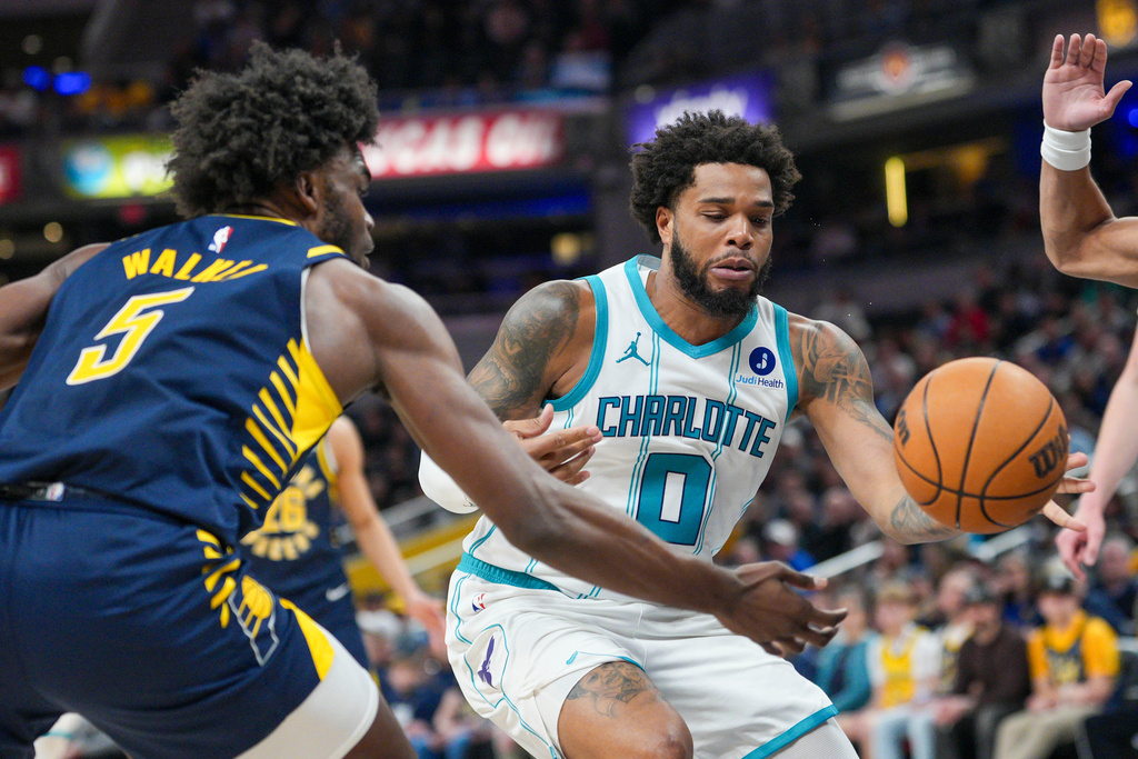Charlotte Hornets forward Miles Bridges (0) looses the ball in front of Indiana Pacers forward Jarace Walker (5) during the first half of an NBA basketball game in Indianapolis, Thursday, Feb. 26, 2026. (AP Photo/AJ Mast)