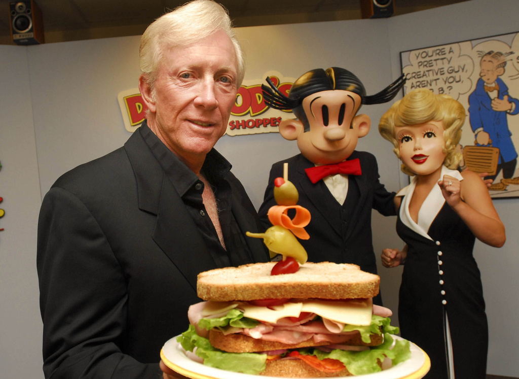 FILE - Dean Young shows off one a Dagwood sandwich at his New Orleans test kitchen Tuesday, May 9, 2006. (AP Photo/Cheryl Gerber, File)