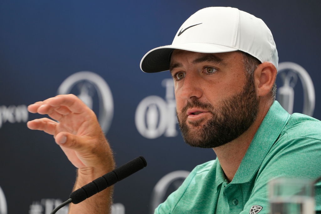 Scottie Scheffler of the United States gestures during a press conference ahead of the British Open Golf championships at Royal Birkdale golf club, in Southport, England, Tuesday, July 14, 2026. (AP Photo/David Goldman)