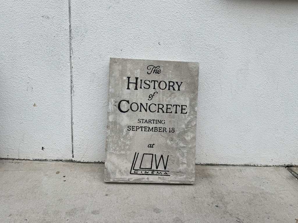 In this photo taken with a smartphone, signage for "The History of Concrete" is pictured outside the Low Cinema on Tuesday, Sept. 8, 2026, in the Ridgewood section of Queens borough of New York. (AP Photo/Jake Coyle)