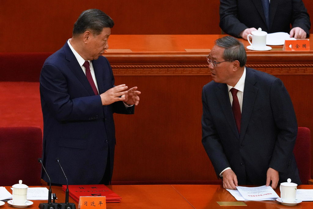 Chinese President Xi Jinping, left, gestures to Chinese Premier Li Qiang during a ceremony to mark the 105th anniversary of the founding of the Chinese Communist Party at the Great Hall of the People in Beijing, Wednesday, July 1, 2026. (AP Photo/Ng Han Guan)