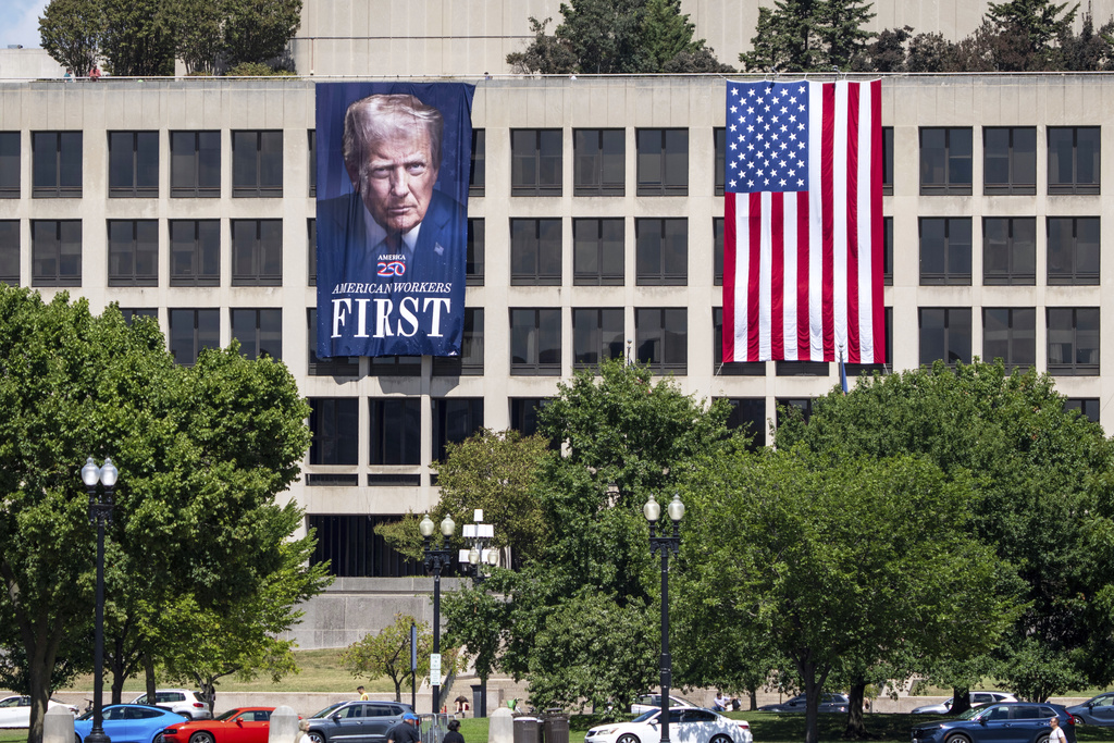 FILE - A portrait of President Donald Trump hangs on the Labor Department headquarters near the Capitol in Washington, Aug. 25, 2025. (AP Photo/J. Scott Applewhite, file)