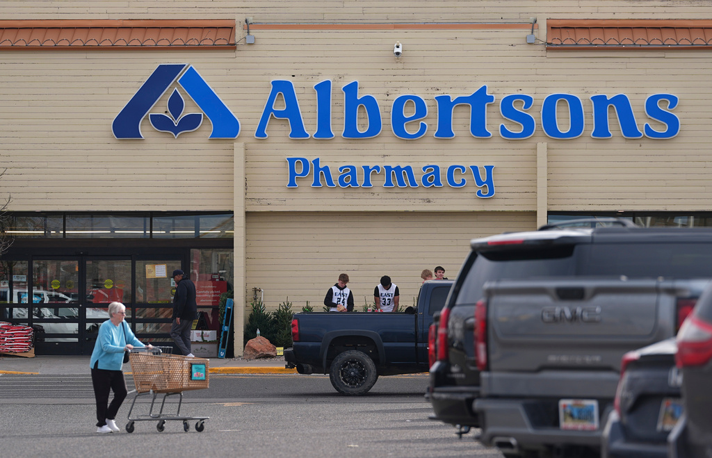 FILE - Shoppers head into an Albertson's grocery store Nov. 23, 2024, in Cheyenne, Wyo. (AP Photo/David Zalubowski, File)