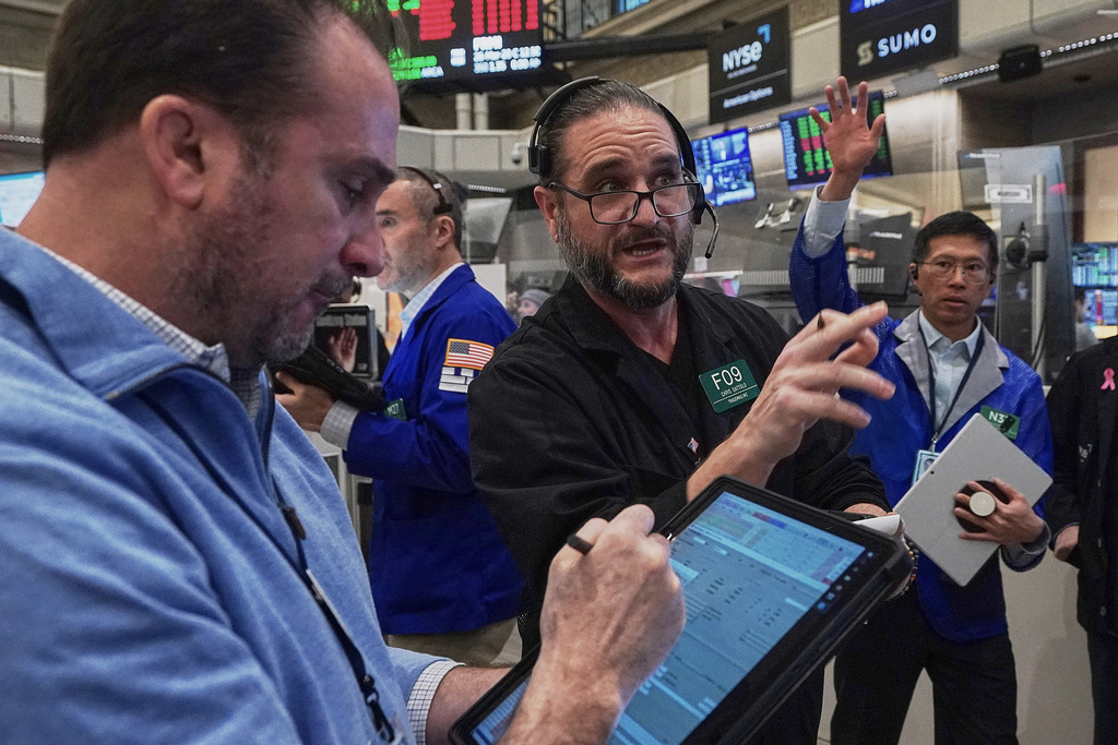 Chris Dattolo, center, works with fellow options traders on the floor of the New York Stock Exchange, Thursday, Jan. 22, 2026. (AP Photo/Richard Drew)