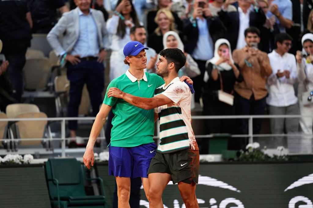 FILE - Winner Spain's Carlos Alcaraz, right, and Italy's Jannik Sinner hug after the final match of the French Tennis Open at the Roland-Garros stadium in Paris, June 8, 2025. (AP Photo/Thibault Camus, File)