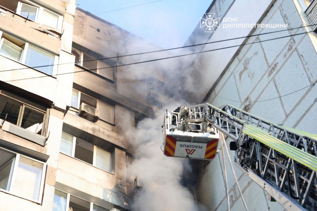 In this photo provided by the Ukrainian Emergency Services on Saturday, Sept. 20, 2025, a rescue worker puts out a fire of a residential house damaged by a Russian strike on Dnipro, Ukraine. (Ukrainian Emergency Service via AP)