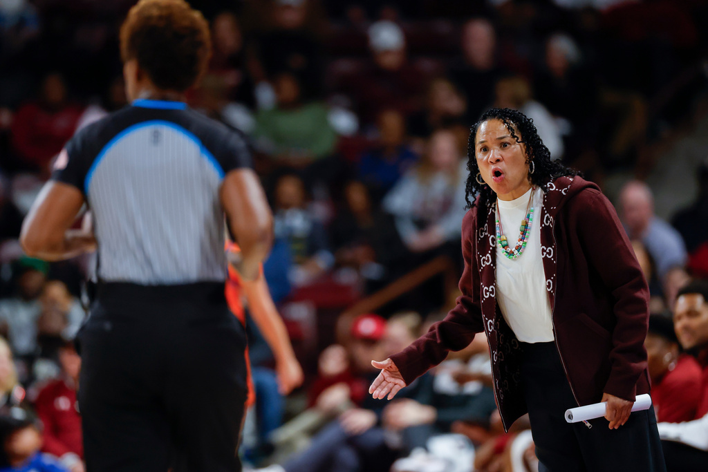 South Carolina head coach Dawn Staley, right, argues with an official during the first half of an NCAA college basketball game against Clemson in Columbia, S.C., Tuesday, Nov. 11, 2025. (AP Photo/Nell Redmond)