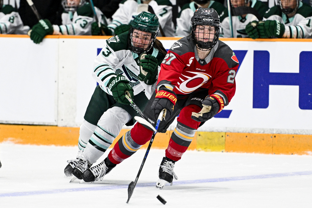 Boston Fleet's Liz Schepers (13) chases down Ottawa Charge's Brooke McQuigge (27) for control of the puck during the second period of an PWHL hockey game in Ottawa, Saturday, Feb. 28, 2026. (Spencer Colby/The Canadian Press via AP)