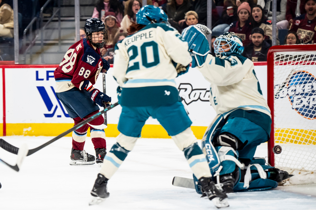 Montreal Victoire's Skylar Irving (88) scores on Seattle Torrent goaltender Hannah Murphy (83) while Torrent's Mariah Keopple (20) defends, during the second period of a PWHL hockey gamen in Laval, Que., on Tuesday, April 7, 2026. (Christopher Katsarov/The Canadian Press via AP)