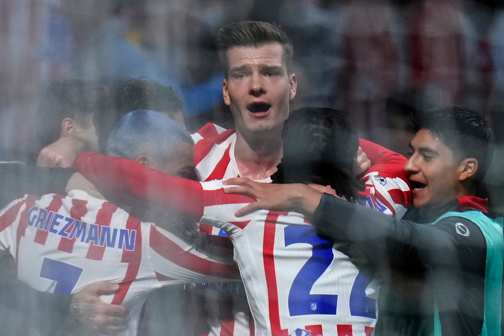 Atletico Madrid's Alexander Sorloth, center, celebrates after scoring his side's third goal during the Champions League play-off second leg soccer match between Atletico Madrid and Club Brugge, in Madrid, Spain, Tuesday, Feb. 24, 2026. (AP Photo/Manu Fernandez)