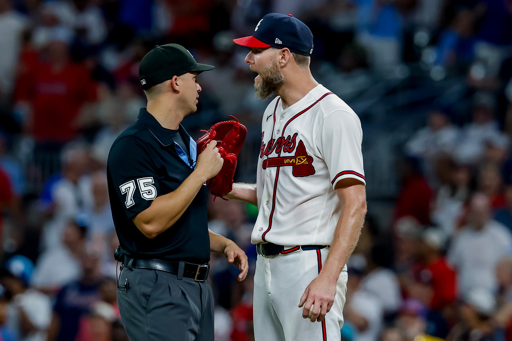 Atlanta Braves pitcher Chris Sale, right, speaks with umpire Edwin Jimenez (75) during a replay review in the ninth inning of a baseball game against the Los Angeles Dodgers, Thursday, Aug. 27, 2026, in Atlanta. (AP Photo/Erik S. Lesser)