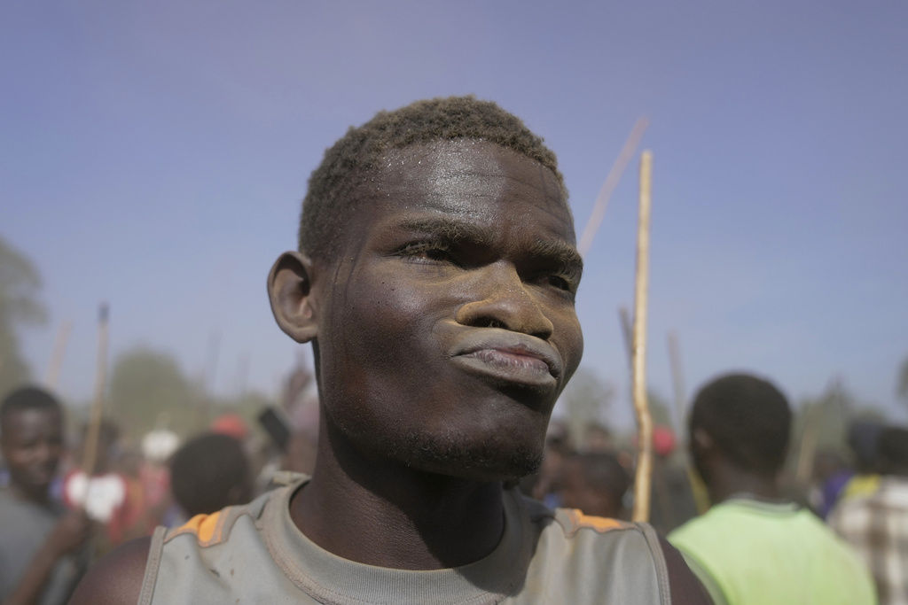 A spectator covered in dust dances after bull Shakahola won bullfighting match, in Kakamega, Kenya, Saturday, Nov. 29, 2025. (AP Photo/Brian Inganga)