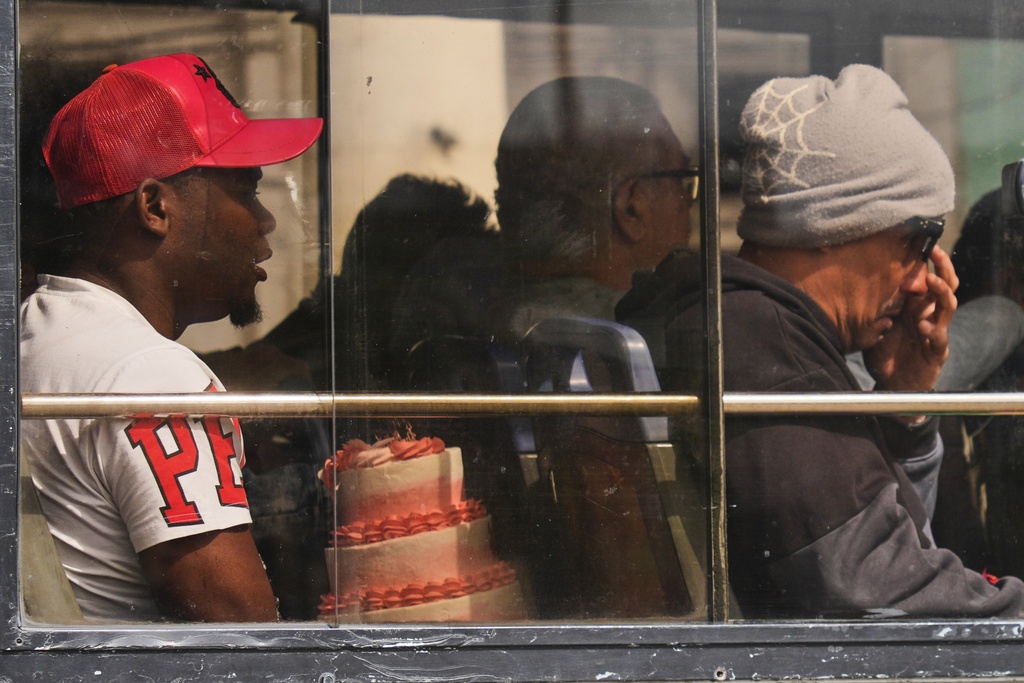 A commuter carries a cake in Havana, Cuba, Friday, Feb. 6, 2026. (AP Photo/Ramon Espinosa)
