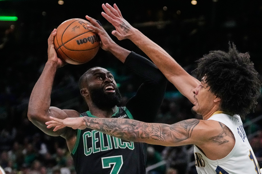 Boston Celtics guard Jaylen Brown (7) drives to the basket against New Orleans Pelicans guard Micah Peavy, right, during the second half of an NBA basketball game, Friday, April 10, 2026, in Boston. (AP Photo/Charles Krupa)
