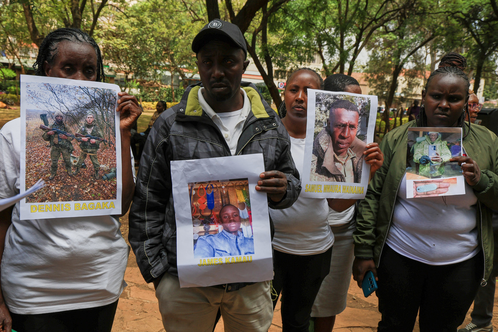 Family members of Kenyans who joined the Russian army in Ukraine hold photos of their loved ones during a protest calling on the government to urgently repatriate them and their remains in Nairobi, Thursday, Feb. 19, 2026. (AP Photo/Andrew Kasuku)