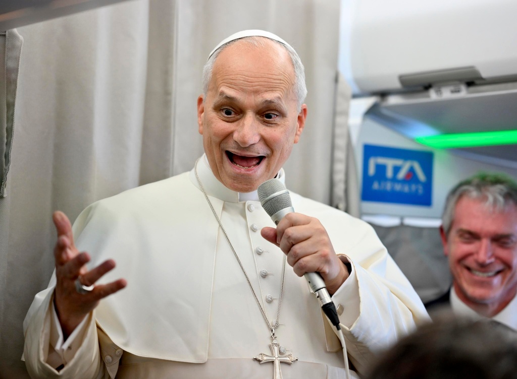Pope Leo XIV talks to reporters aboard an airplane as he returns from a six-day visit to Turkey and Lebanon, Tuesday, Dec. 2, 2025. (Alessandro Di Meo/Pool Photo via AP)