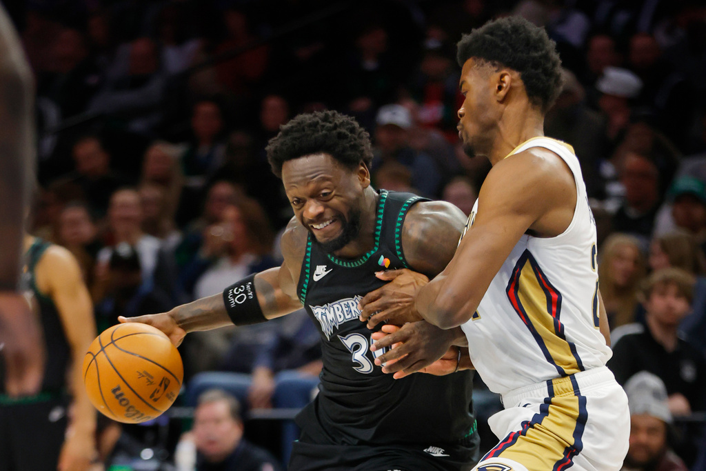 Minnesota Timberwolves forward Julius Randle, left, works against New Orleans Pelicans center Yves Missi in the first quarter of an NBA basketball game Friday, Feb. 6, 2026, in Minneapolis. (AP Photo/Bruce Kluckhohn)