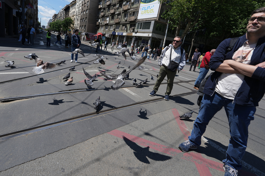 University students and citizens stand in silence during commemorative traffic blockade to a train station tragedy that killed 16 people before the first big rally this year of opponents of President Aleksandar Vucic in Belgrade, Serbia, Monday, May 18, 2026. (AP Photo/Darko Vojinovic)