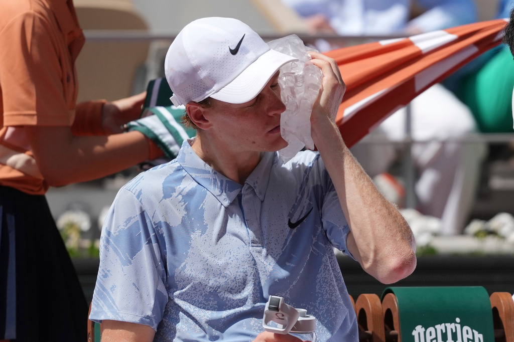 Jannik Sinner of Italy cools himself with the ice during the second round men's singles tennis match against Juan Manuel Cerundolo of Argentina at the French Open tennis tournament in Paris, Thursday, May 28, 2026. (AP Photo/Thibault Camus)