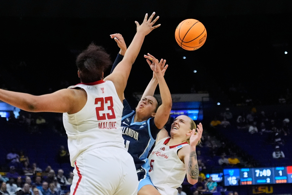 Villanova guard Jasmine Bascoe (11) battles under the basket between Texas Tech forward Jada Malone (23) and guard Denae Fritz (5) during the first half in the first round of the NCAA college basketball tournament, Friday, March 20, 2026, in Baton Rouge, La. (AP Photo/Gerald Herbert)