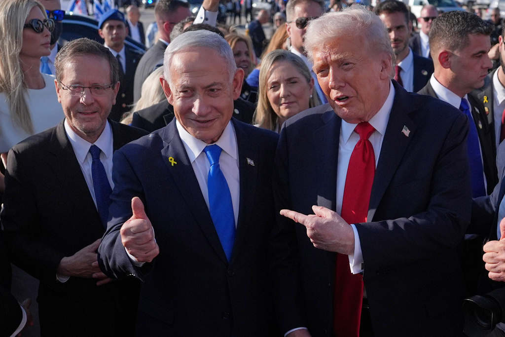 President Donald Trump poses for a photo with Israel's Prime Minister Benjamin Netanyahu before he boards Air Force One at Ben Gurion International Airport, Monday, Oct. 13, 2025, near Tel Aviv, as Israel's President Isaac Herzog watches at left. (AP Photo/Evan Vucci)