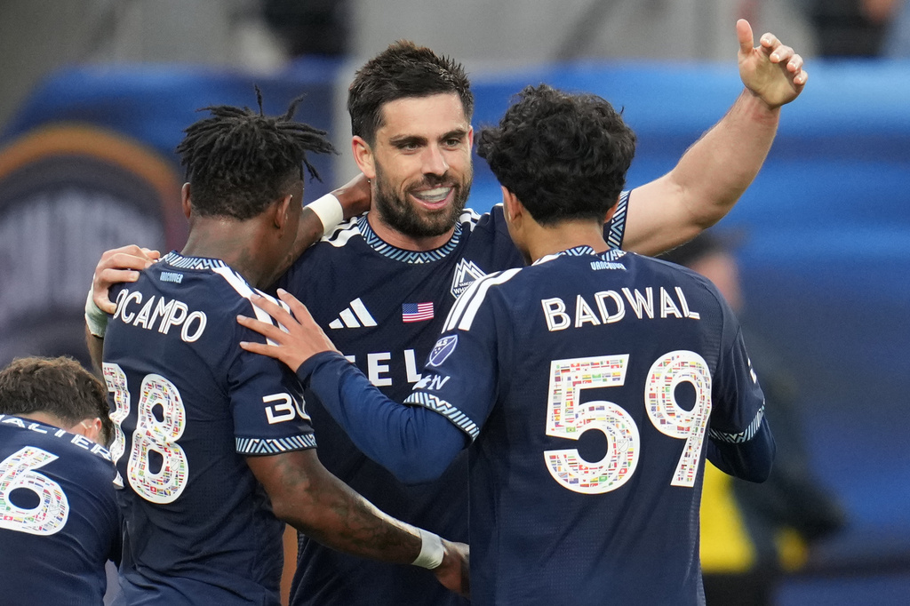 Vancouver Whitecaps FC forward Brian White, center, celebrates his goal with teammates midfielder Jeevan Badwal (59) and defender Édier Ocampo, left, during the first half of an MLS soccer match against San Diego FC Saturday, May 23, 2026, in San Diego. (AP Photo/Gregory Bull)