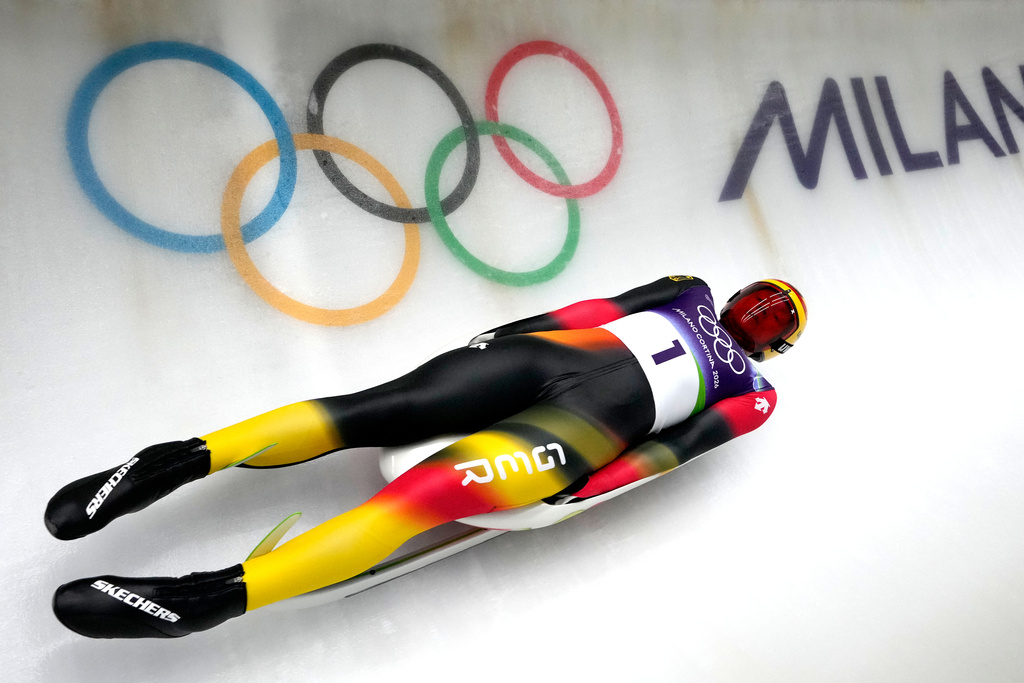 Germany's Max Langenhan slides down the track during a men's single luge training session at the 2026 Winter Olympics, in Cortina d'Ampezzo, Italy, Saturday, Feb. 7, 2026. (AP Photo/Aijaz Rahi)