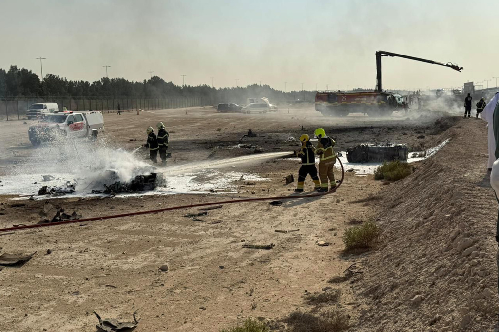 Emergency services attend the scene after an Indian HAL Tejas crashed during a demonstration at the Dubai Air Show, at Al Maktoum International Airport at Dubai World Central, Dubai, United Arab Emirates, Friday Nov. 21, 2025. (Dubai Media Office via AP)