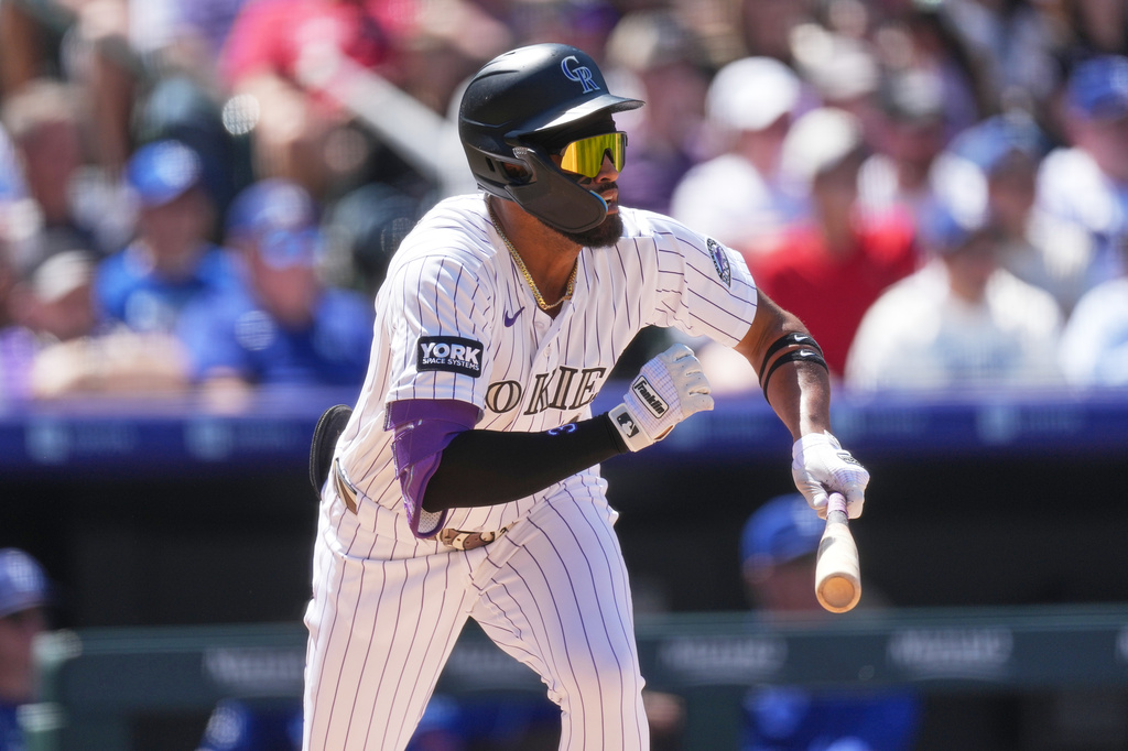 Colorado Rockies' Willi Castro heads up the first base line after grounding into a double play to end the fourth inning of a baseball game against the Los Angeles Dodgers, Sunday, April 19, 2026, in Denver. (AP Photo/David Zalubowski)