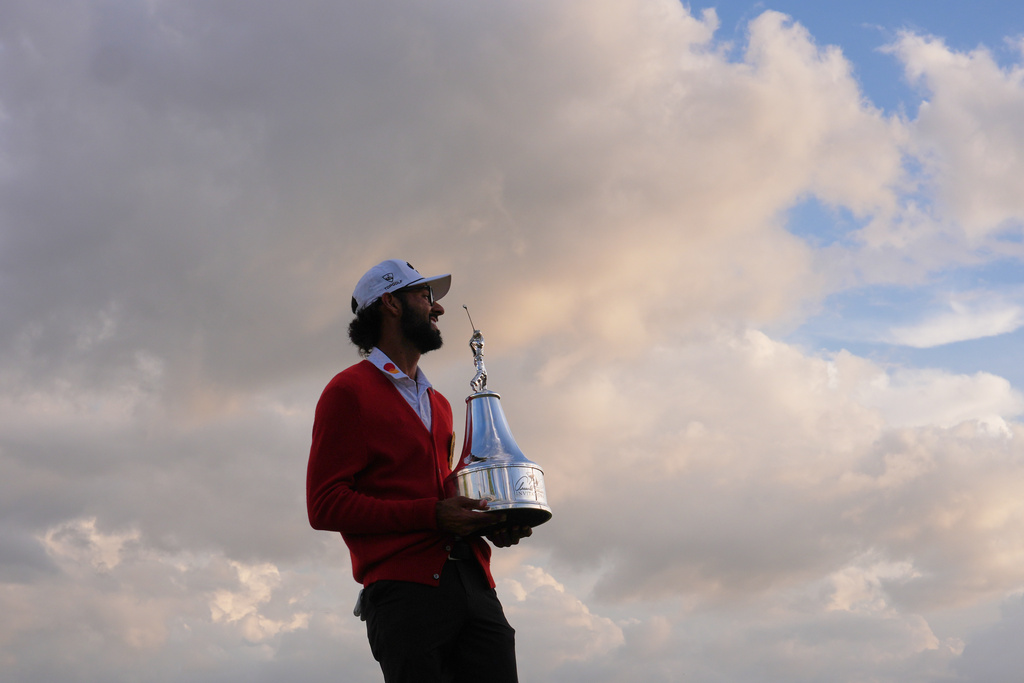 Akshay Bhatia smiles as he holds the championship trophy after winning the Arnold Palmer Invitational at Bay Hill golf tournament Sunday, March 8, 2026, in Orlando, Fla. (AP Photo/Matt Slocum)