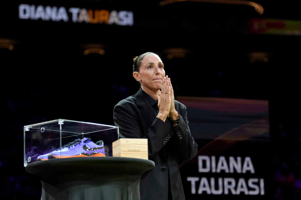 Retired WNBA Phoenix Mercury basketball player Diana Taurasi acknowledges the cheering crowd as she is honored during a halftime Ring of Honor ceremony Sunday, Aug. 16, 2026, in Phoenix. (AP Photo/Ross D. Franklin)