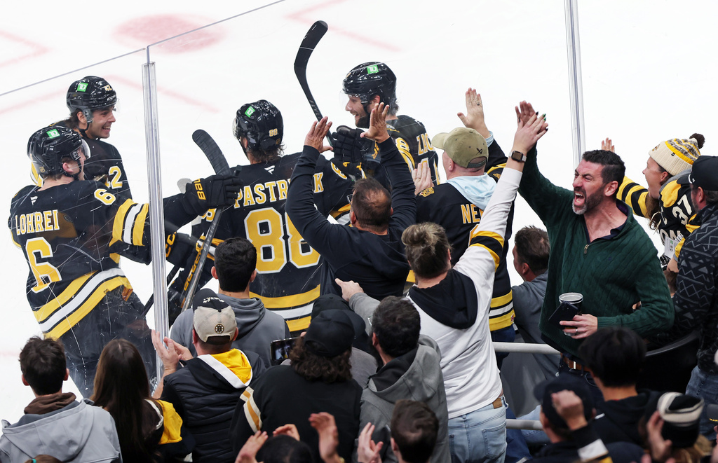 Boston Bruins winger David Pastrnak (88) celebrates with teammates as fans react after he scored a third-period goal during an NHL hockey game against the San Jose Sharks, Saturday, Oct. 24, 2026, in Boston. (AP Photo/Jim Davis)