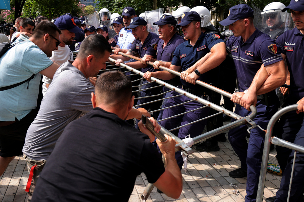 Protesters try to remove a barricade as police hold it during clashes at an anti-government rally in Tirana, Albania, Thursday, July 2, 2026. (AP Photo/Hameraldi Agolli)