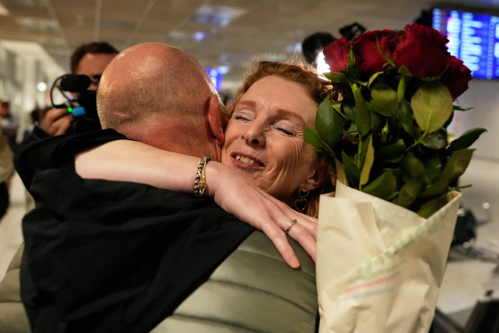 People arrive at the International Airport in Frankfurt, Germany, after being evacuated from Dubai on a commercial flight, Tuesday, March 3, 2026. (AP Photo/Michael Probst)