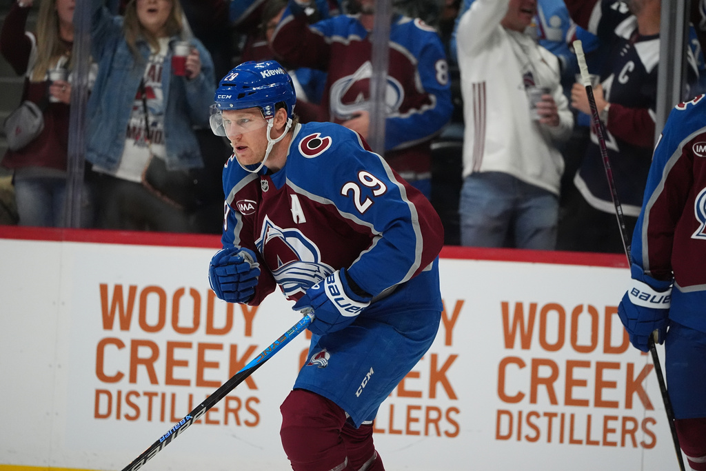 Colorado Avalanche center Nathan MacKinnon reacts after scoring against the Boston Bruins in the first period of an NHL hockey game Saturday, Oct. 18, 2025, in Denver. (AP Photo/David Zalubowski)