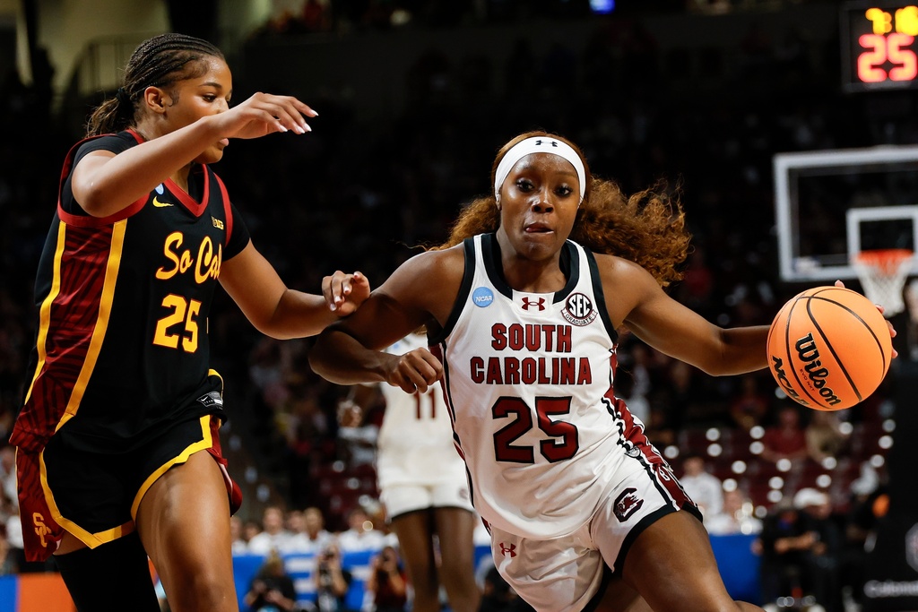 South Carolina guard Raven Johnson, right, drives to the basket against Southern California guard Kara Dunn during the first half in the second round of the NCAA college basketball tournament, Monday, March 23, 2026, in Columbia, S.C. (AP Photo/Nell Redmond)