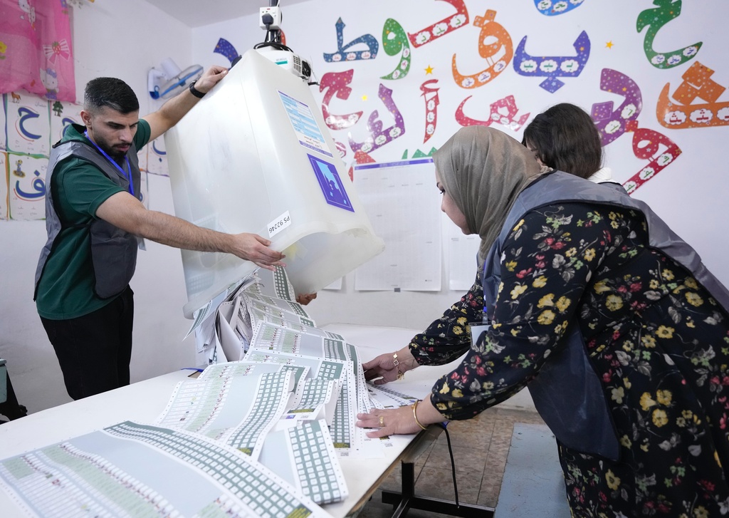 FILE - Election workers count ballots as they close a polling station, during the parliamentary elections in Baghdad, Iraq, Nov. 11, 2025. (AP Photo/Hadi Mizban, File)