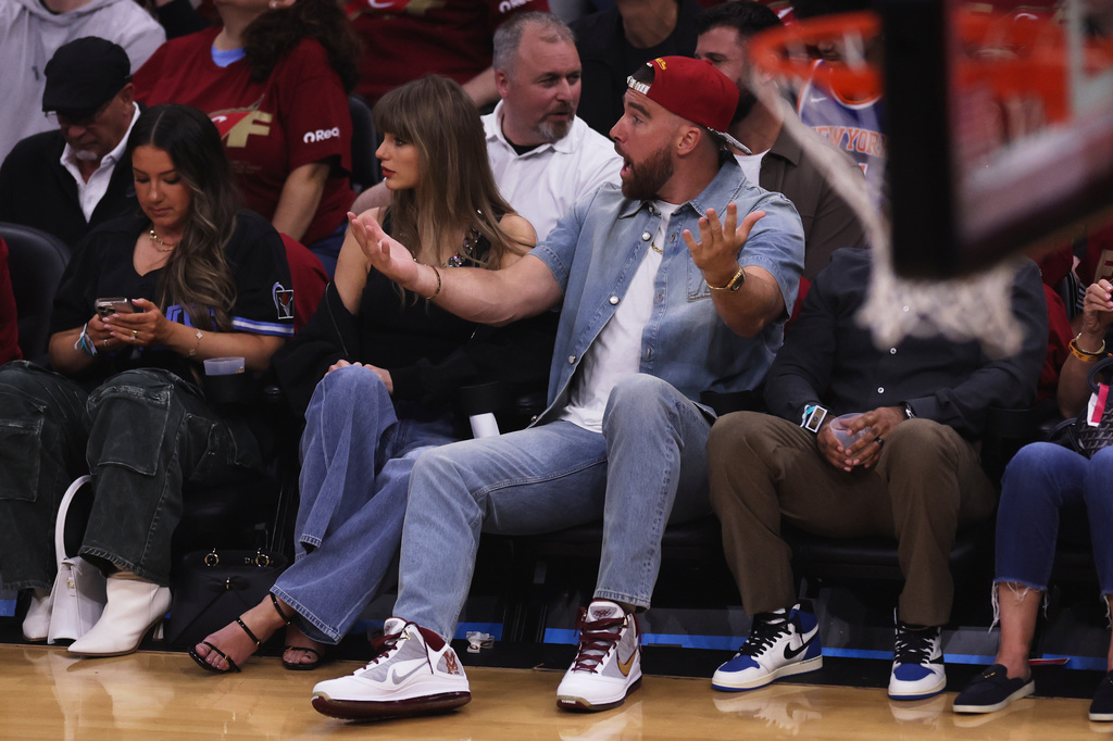 Taylor Swift and Travis Kelce watch the first half of Game 3 in the Eastern Conference finals NBA basketball playoffs series between the New York Knicks and the Cleveland Cavaliers in Cleveland, Saturday, May 23, 2026. (AP Photo/Tim Phillis)