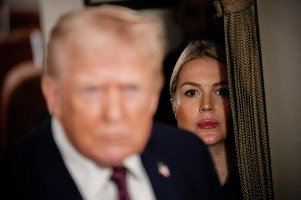 FILE - White House press secretary Karoline Leavitt watches as President Donald Trump speaks to reporters while in flight on Air Force One to Joint Base Andrews, Md., Jan. 11, 2026. (AP Photo/Julia Demaree Nikhinson, File)