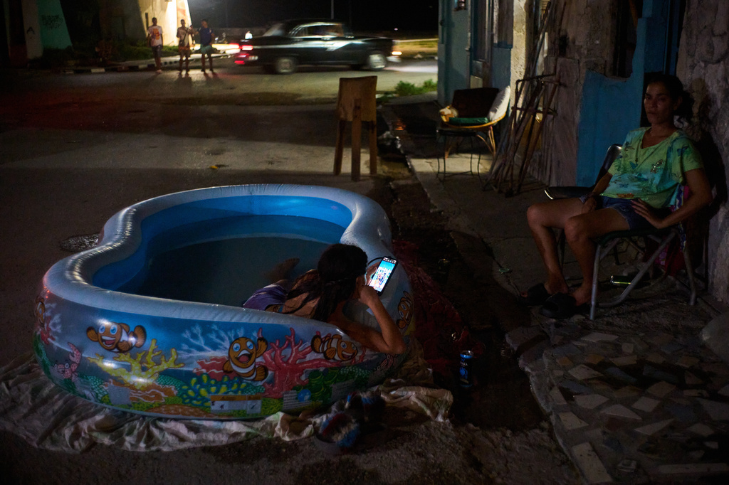 A girl cools off in a plastic pool in the street in Havana, Cuba, Tuesday, Aug. 4, 2026. (AP Photo/Ramon Espinosa)