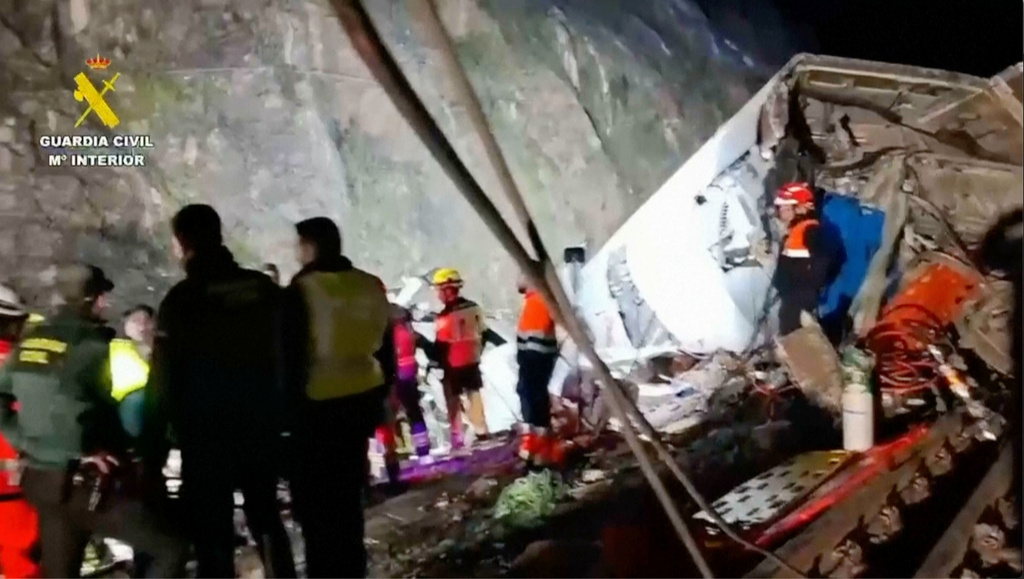In this grab taken from video provided by Guardia Civil, rescue workers at the scene after a high speed train collision,in Adamuz, Spain, Monday, Jan. 19, 2026. (Guardia Civil via AP)
