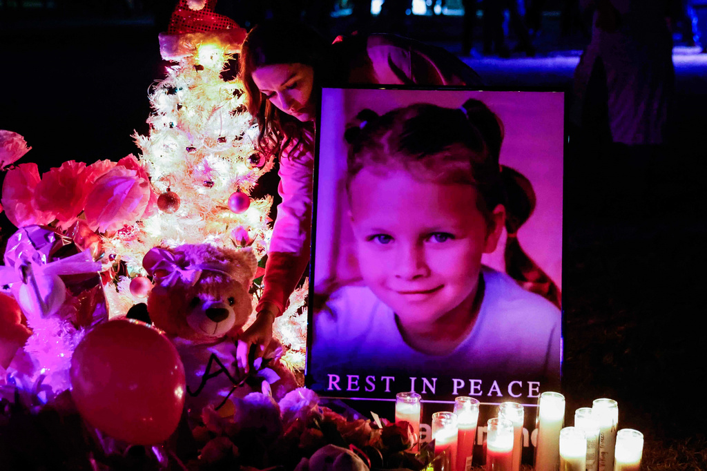 FILE - Attendees offer their respects at a makeshift memorial for Athena Strand after a memorial service, Dec. 6, 2022, in Paradise, Texas. (Shafkat Anowar/The Dallas Morning News via AP, File)