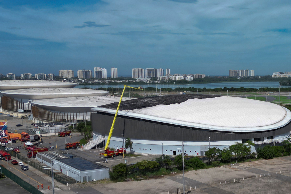 Firefighters work to control the fire on the roof of Rio de Janeiro's Olympic Park velodrome, Wednesday, April 8, 2026. (AP Photo/Bruna Prado)