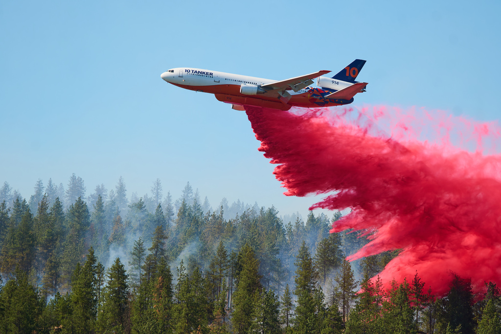Fire retardant is dropped by air tanker onto the Upriver Fire on Tuesday, June 16, 2026 in Spokane, Wash. (Skyler Geissler via AP)