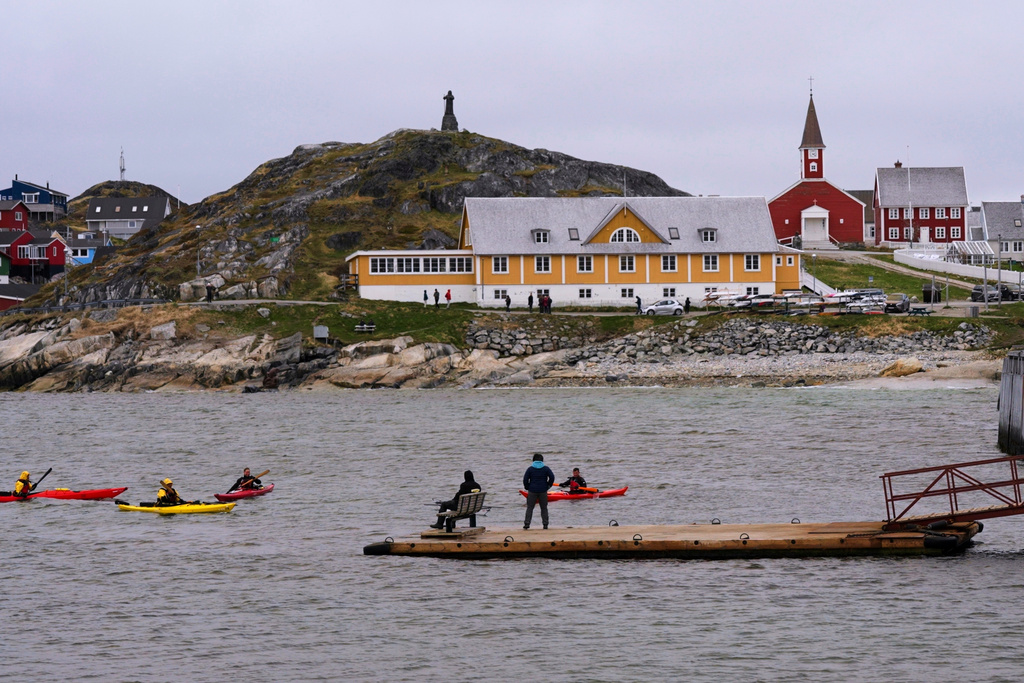 FILE - Tourists kayak at sea in front of Nuuk Cathedral in Nuuk, Greenland, June 16, 2025. (AP Photo/Kwiyeon Ha, File)