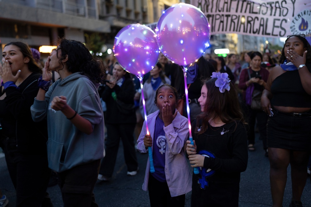 People celebrate International Women's Day in downtown Montevideo, Uruguay, Sunday, March 8, 2026. (AP Photo/Matilde Campodonico)
