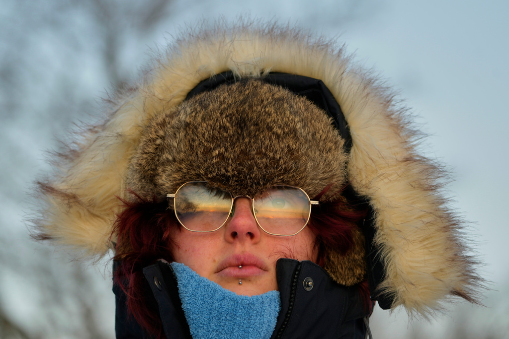 Emma Nadeau, of North Yarmouth, Maine, is bundled against the cold as she watches the sunrise on a 1-degree F. morning, Saturday, Jan. 24, 2026, in Portland, Maine. (AP Photo/Robert F. Bukaty)