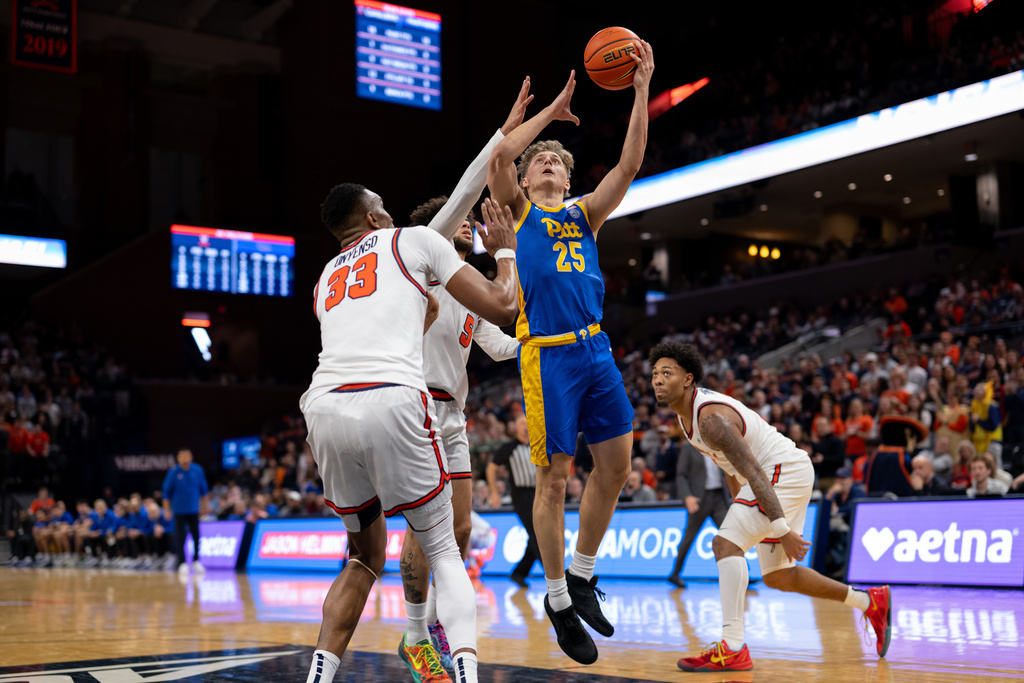 Pittsburgh guard Nojus Indrusaitis (25) drives to the basket against Virginia center Ugonna Onyenso (33) during the first half of an NCAA college basketball game, Tuesday, Feb. 3, 2026, in Charlottesville, Va. (AP Photo/Robert Simmons)