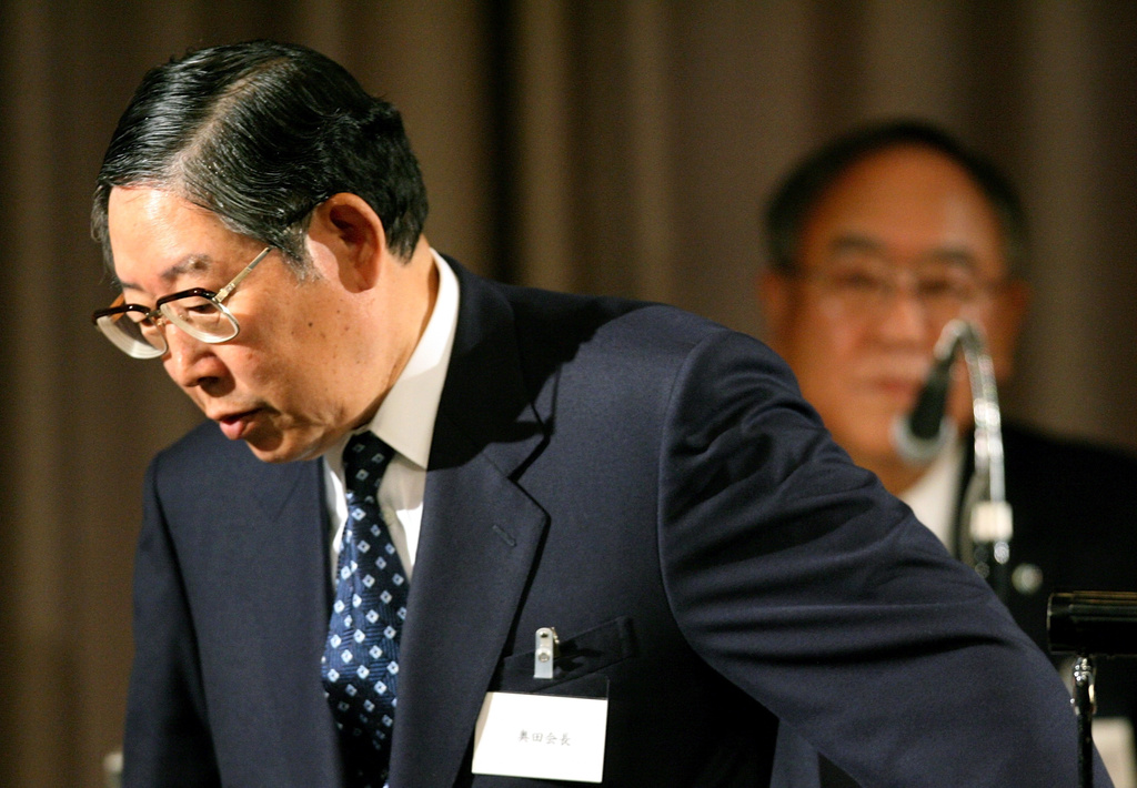 FILE - Outgoing chairman of the Japan's foremost business lobby, the Nippon Keidanren, Hiroshi Okuda, left, leaves the podium following his one and the last speech as a chairman as newly named chairman Fujio Mitarai, Canon Corps Chief Executive Officer looks on during the annual meeting in Tokyo, May 24, 2006. (AP Photo/Junji Kurokawa, File)
